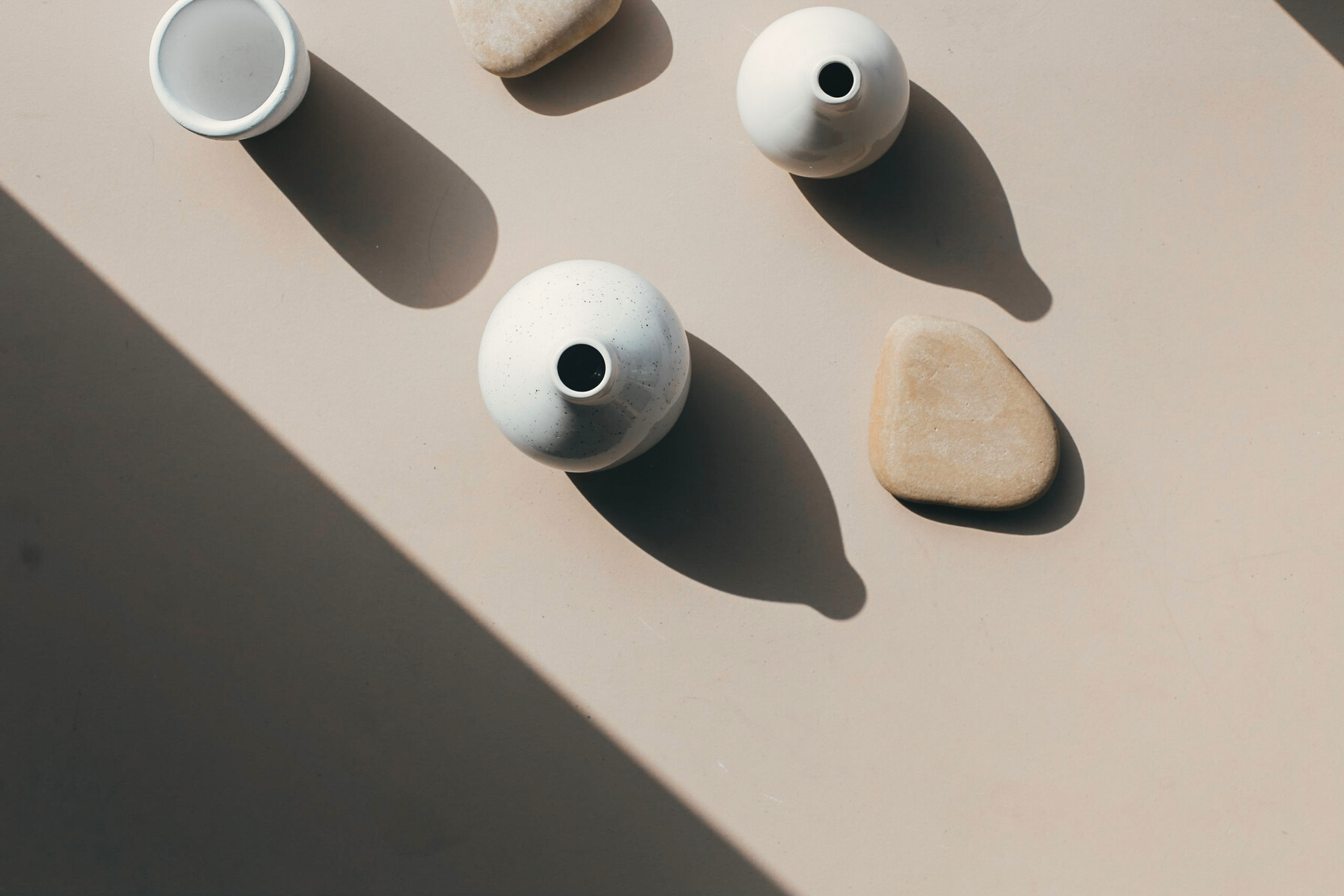 Overhead Shot of White Vases on a Beige Surface